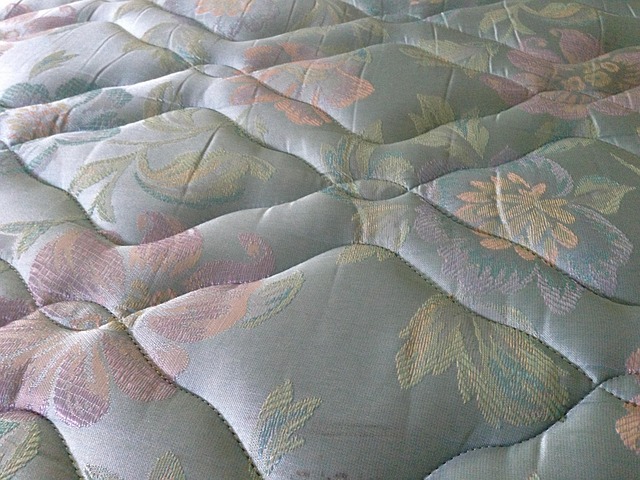 close-up of neutral bedding textiles cotton linen and satin weave texture on a bed