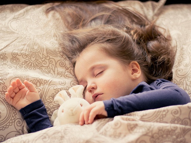 neatly layered bedding with duvet cover, blanket and throw in cream and beige palette